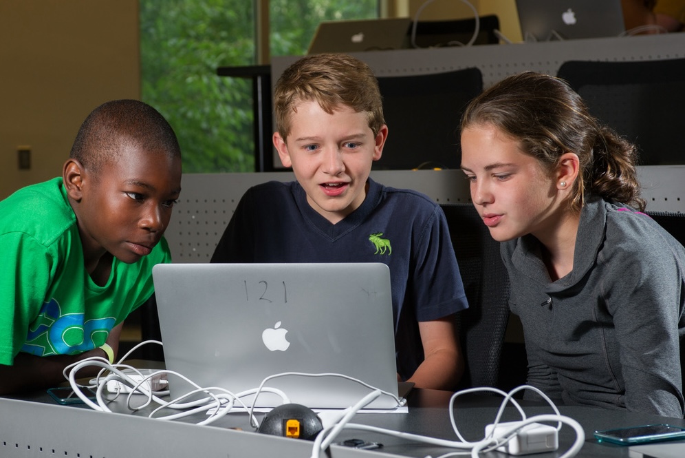 K-12 students working on computer together.