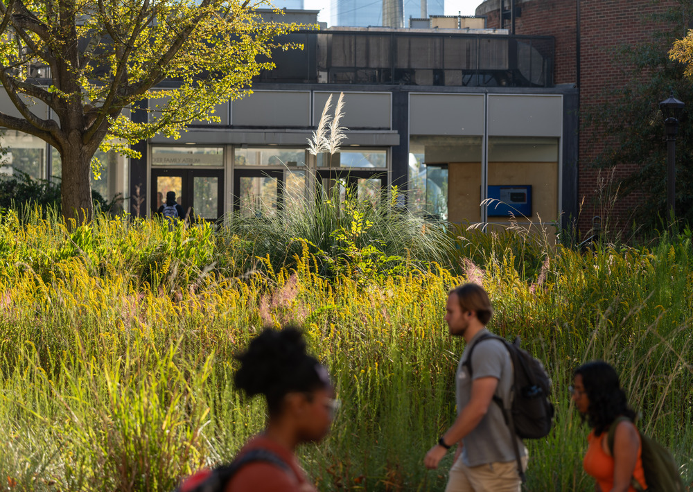 Students walking past an engineering building on campus.