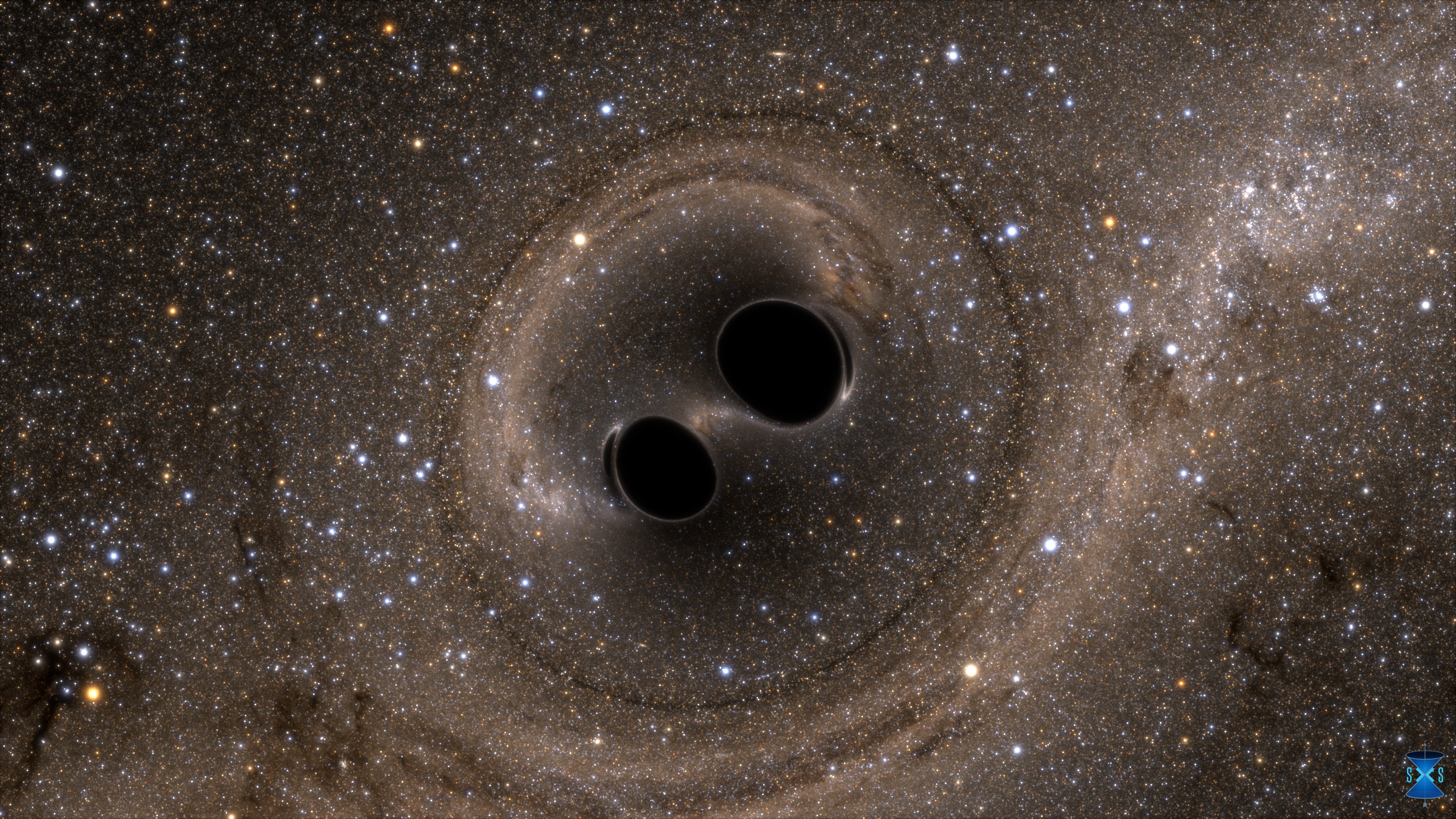 The collision of two black holes holes—a tremendously powerful event detected for the first time ever by the Laser Interferometer Gravitational-Wave Observatory, or LIGO—is seen in this still from a computer simulation. Image Credit: SXS, the Simulating eXtreme Spacetimes (SXS) project